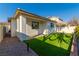 A backyard featuring new low-maintenance synthetic turf, block wall and desert landscaping at 669 Elliot Peak Ave, Las Vegas, NV 89183