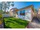 A backyard featuring new low-maintenance synthetic turf, a covered patio and desert landscaping at 669 Elliot Peak Ave, Las Vegas, NV 89183