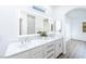 Bathroom featuring double sinks, quartz countertops, and an LED mirror at 669 Elliot Peak Ave, Las Vegas, NV 89183