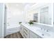 Bathroom featuring double sinks, quartz countertops, and a large mirror at 669 Elliot Peak Ave, Las Vegas, NV 89183