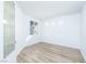 Clean and minimalist bedroom showcasing a large window and wood-style flooring at 669 Elliot Peak Ave, Las Vegas, NV 89183