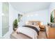 Cozy bedroom with neutral decor, large window, and a stylish accent door at 669 Elliot Peak Ave, Las Vegas, NV 89183