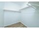 Walk-in closet with built-in shelving and wood-look floors at 669 Elliot Peak Ave, Las Vegas, NV 89183