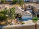 Charming single-story home with a well-manicured front yard, two-car garage and a desert landscape at 669 Elliot Peak Ave, Las Vegas, NV 89183