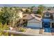 Charming single-story home with a well-manicured front yard, two-car garage and desert landscaping at 669 Elliot Peak Ave, Las Vegas, NV 89183