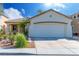 Charming single-story home featuring a two-car garage, desert landscaping, and a neutral color scheme at 669 Elliot Peak Ave, Las Vegas, NV 89183