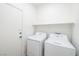 Laundry room with new appliances and a storage shelf at 669 Elliot Peak Ave, Las Vegas, NV 89183