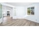 Open living room with stylish glass door leading to a bright, white kitchen at 669 Elliot Peak Ave, Las Vegas, NV 89183