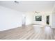 Spacious living area with wood flooring, lots of natural light, and a view to the hallway at 669 Elliot Peak Ave, Las Vegas, NV 89183