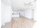 Open-concept living room boasts wood floors and a view of the modern kitchen at 669 Elliot Peak Ave, Las Vegas, NV 89183
