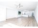 Bright, open-concept living room featuring hardwood floors, white walls, and a ceiling fan at 669 Elliot Peak Ave, Las Vegas, NV 89183