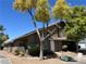 Charming townhome featuring a terra cotta roof, desert landscaping and a welcoming front entrance at 6908 Cornflower Dr, Las Vegas, NV 89128