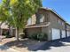 Inviting two-story townhome with attached garage and mature trees, offering a blend of comfort at 6908 Cornflower Dr, Las Vegas, NV 89128