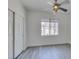 Bright bedroom features a window, closet, ceiling fan, and plank flooring at 7151 S Durango Dr # 211, Las Vegas, NV 89113