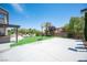 Expansive backyard featuring a basketball court, artificial turf, and a covered patio, perfect for recreation and relaxation at 7538 Mustang St, Las Vegas, NV 89131
