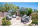 Outdoor living with a fire pit, patio seating and lush landscaping, perfect for entertaining or relaxing at 7538 Mustang St, Las Vegas, NV 89131