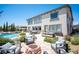 Entertain in style with outdoor patio, fire pit, comfortable seating, and beautiful landscaping with pool in the distance at 7538 Mustang St, Las Vegas, NV 89131