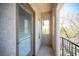 Private balcony with views of nature, stucco walls, a sliding glass door and black iron railing at 7538 Mustang St, Las Vegas, NV 89131