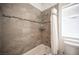 Well-maintained bathroom features tile shower and tub, a decorative tile accent, and neutral paint at 7538 Mustang St, Las Vegas, NV 89131