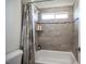Bathroom featuring a shower-tub combo with tiled walls, shower curtain, and recessed lighting at 7538 Mustang St, Las Vegas, NV 89131