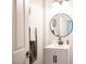 Bright bathroom featuring a modern vanity, round mirror, and stylish fixtures at 7538 Mustang St, Las Vegas, NV 89131
