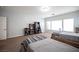 Bedroom with two beds featuring a hanging chair, a closet, a dresser, and plenty of natural light at 7538 Mustang St, Las Vegas, NV 89131