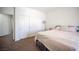 Bedroom with neutral walls, double-door closet, carpeted floors, and a bed with throw blanket at 7538 Mustang St, Las Vegas, NV 89131