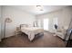 Spacious bedroom with neutral walls, carpeted floors, access to patio, and full length mirror at 7538 Mustang St, Las Vegas, NV 89131