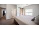 Bedroom with a view, features barn door, large window, plush carpet, and plenty of natural light at 7538 Mustang St, Las Vegas, NV 89131