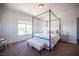 Bright bedroom featuring a four poster bed, neutral color scheme, and a hanging chair by the window at 7538 Mustang St, Las Vegas, NV 89131
