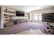 Bright bonus room features custom shelving, large tv, natural light, and space for games and relaxation at 7538 Mustang St, Las Vegas, NV 89131