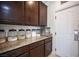 Butler's pantry with dark wood cabinets and granite countertops at 7538 Mustang St, Las Vegas, NV 89131