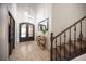 Elegant entryway with a high ceiling, ornate front door, travertine floors, and decorative mirror at 7538 Mustang St, Las Vegas, NV 89131