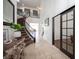 Inviting foyer features travertine flooring, a curved staircase, and a view into the light filled living spaces at 7538 Mustang St, Las Vegas, NV 89131