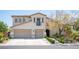 Charming two-story home with stucco exterior, two-car garage, and manicured front yard landscaping at 7538 Mustang St, Las Vegas, NV 89131