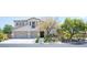 Charming two-story home with stucco exterior, two-car garage, and mature trees in the front yard at 7538 Mustang St, Las Vegas, NV 89131