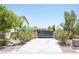 Home's gated entrance and landscaped front yard create an inviting curb appeal at 7538 Mustang St, Las Vegas, NV 89131