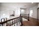 Hallway featuring wood banister, carpeted floors, wrought iron spindles, and decorative light fixtures at 7538 Mustang St, Las Vegas, NV 89131
