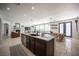 Open concept kitchen with a large island, and stainless steel appliances with travertine flooring at 7538 Mustang St, Las Vegas, NV 89131
