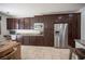 Gourmet kitchen featuring stainless steel appliances and a large island with travertine floors at 7538 Mustang St, Las Vegas, NV 89131