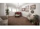 Spacious living room featuring a piano, couch, and ample natural light at 7538 Mustang St, Las Vegas, NV 89131