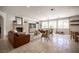 Large living room includes stone floors, fireplace, and large windows providing natural light at 7538 Mustang St, Las Vegas, NV 89131