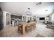 Open concept living space features stone floors, kitchen island, stainless appliances, and modern lighting at 7538 Mustang St, Las Vegas, NV 89131