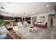 Expansive living room and kitchen area with stone floors, stylish furniture, and modern appliances at 7538 Mustang St, Las Vegas, NV 89131