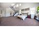 Spacious main bedroom suite with carpet, high ceilings, ample natural light, and seating area at 7538 Mustang St, Las Vegas, NV 89131