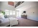 Bright main bedroom with plush carpet, high ceilings, and an outside entrance at 7538 Mustang St, Las Vegas, NV 89131