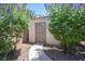 Outdoor shed located on a pathway surrounded by mature foliage for storage and outdoor equipment and tools at 7538 Mustang St, Las Vegas, NV 89131