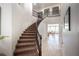 Elegant curved staircase with iron railings and a view into the light filled living spaces at 7538 Mustang St, Las Vegas, NV 89131