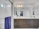 Bright bathroom featuring double sinks, sleek cabinetry, and a glass-enclosed shower at 7756 Seville Estates Ct, Las Vegas, NV 89113