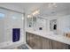 Modern bathroom features double sinks, walk-in shower, and ample countertop space at 7756 Seville Estates Ct, Las Vegas, NV 89113